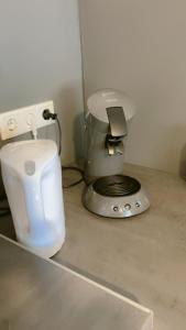 a kitchen counter with a coffee maker and a mixer at hoteliving am Bahnhof in Pohlheim