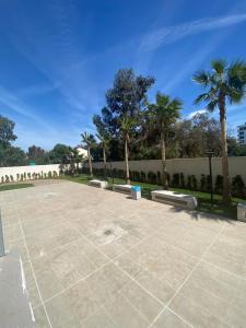 a parking lot with palm trees in a park at prestigieuse à casa finance city in Casablanca