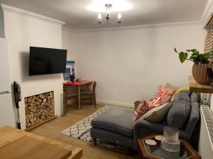 a living room with a couch and a fire place at Beach Hideaway in Shanklin