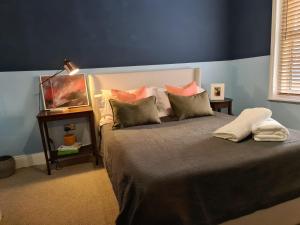 a bedroom with a bed with pillows on it at Beach Hideaway in Shanklin