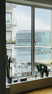 a window with a view of the ocean and a harbor at ApartmentInCopenhagen Apartment 1596 in Copenhagen