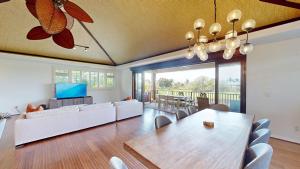 a living room with a table and a couch at SEASCAPE Delightful 3BR Detached KaMilo Home with Heated Pool in Waikoloa