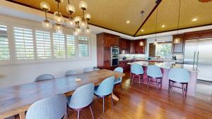 a kitchen with a large wooden table and chairs at SEASCAPE Delightful 3BR Detached KaMilo Home with Heated Pool in Waikoloa