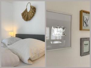 a bedroom with a mirror and a bed and a picture at STRANDNEST NORDDEICH in Norddeich