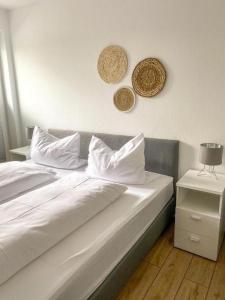 a bed with white sheets and pillows on it at STRANDNEST NORDDEICH in Norddeich