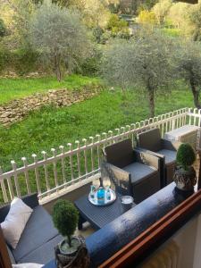 a balcony with two chairs and a table and a fence at Casa Giuly in Rapallo