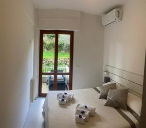 a bedroom with a bed with two towels on it at Casa Giuly in Rapallo +20 photos