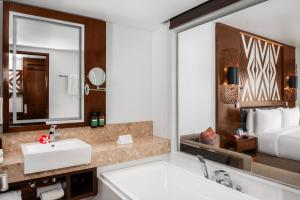 a bathroom with a sink and a large mirror at Crowne Plaza Fiji Nadi Bay Resort & Spa, an IHG Hotel in Nadi