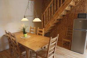 a kitchen and dining room with a wooden table and chairs at Chalupa Granát in Kořenov