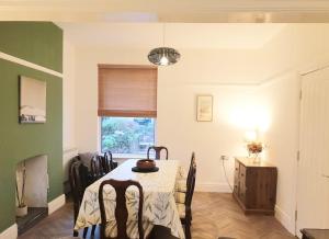 a dining room with a table and a window at Beach House, Llanddulas near Colwyn Bay in Llanddulas