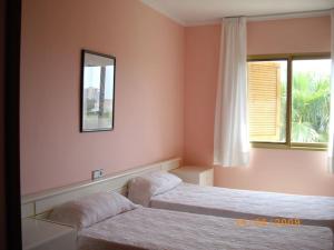 a bedroom with two beds and a mirror on the wall at Chalet in PEÑISCOLA in Peñíscola