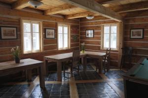 a dining room with tables and chairs in a cabin at Chalupa Granát in Kořenov
