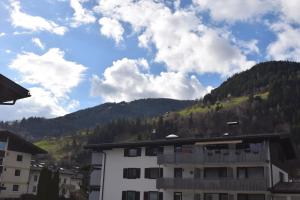 a view of a building with mountains in the background at Alpha Alpin Apartment in Zell am See