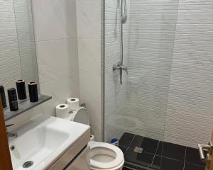 a bathroom with a shower and a toilet and a sink at Appartement Plage près d’Agadir in Aourir