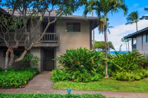 a building with a balcony and palm trees at K B M Resorts: Kaanapalii Plantation Villa KPL-55 Partial Ocean Views Includes Rental Car in Kaanapali