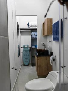 a bathroom with a white toilet and a sink at Aparta-estudio completo en Itagüí - 501 in Itagüí