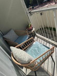 a wicker chair and pillow on a balcony at Av de las rosas in Guadalajara