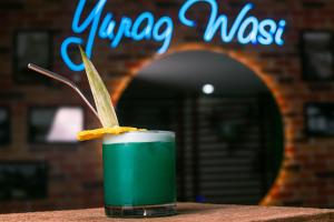 uma bebida verde sentada em cima de uma mesa em YURAQ WASI Hotel/Restobar em Huánuco