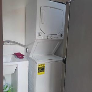 a refrigerator with a microwave on top of it at Ocean Breeze Apartment in La Romana in La Romana