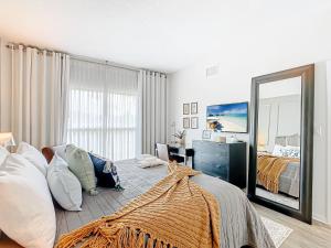 a bedroom with a bed and a large mirror at 1Bed/1Bath Pet Friendly Condo at the Melia in Orlando