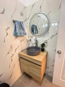 a bathroom with a sink and a mirror at Richie’s House En Licey Al Medio in Santiago de los Caballeros