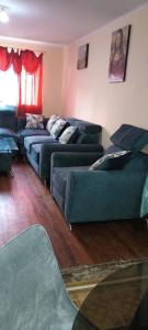a living room with two green couches at Mi casa tu casa. My house in La Paz