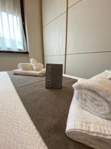 a bedroom with two beds and a book on the floor at Casa Oasi in Seriate