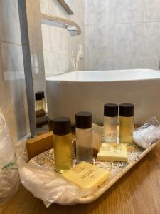 a tray with four bottles of soap and a bath tub at Casa Oasi in Seriate +20 photos