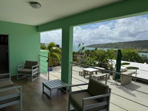 a balcony with chairs and a view of the ocean at Villa Ensenada Honda in Culebra