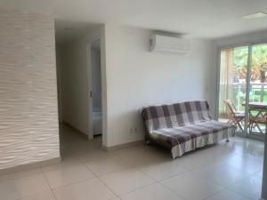 a living room with a couch and a window at Beach Place Aquiraz Riviera in Aquiraz