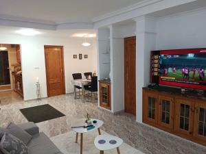 a living room with a couch and a tv at campoamor 34 in Orihuela