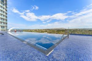 a swimming pool with a view of a building at Bright 1-Bed by Natural Reserves with Pool & Gym in Harrison