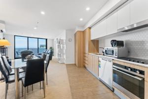 a kitchen and dining room with a table and chairs at Bright 1-Bed by Natural Reserves with Pool & Gym in Harrison