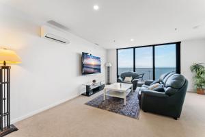 a living room with a couch and a table at Bright 1-Bed by Natural Reserves with Pool & Gym in Harrison