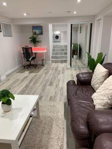 een woonkamer met een bank en een tafel bij Luxurious brand new ground level apartment in Mississauga