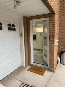 a door to a house with a door that says welcome at Luxurious brand new ground level apartment in Mississauga