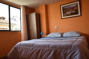 a bedroom with a bed and a large window at Saga Andina II in Cusco