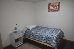 a bedroom with a bed and a nightstand with a picture on the wall at Saga Andina II in Cusco +15 photos
