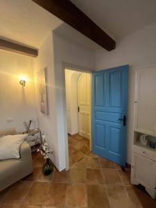 a room with a blue door and a bedroom at Villa Maria Citara Beach in Forio d'Ischia