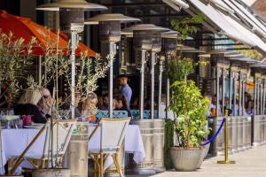 een groep mensen die aan tafel zitten in een restaurant bij Harbour View Woolloomooloo in Sydney