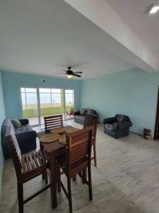 a living room with a table and chairs and a couch at Tranquil Waterfront Escape in Orange Walk