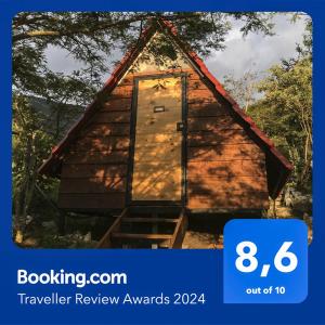 a sign that reads travel review awards with a photo of a cabin at Cabañas Yei Calli in Ciudad Mendoza