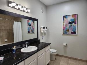a bathroom with a sink and a toilet at Relax and indulge in luxury! in Kissimmee