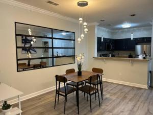 a kitchen and dining room with a table and chairs at Relax and indulge in luxury! in Kissimmee