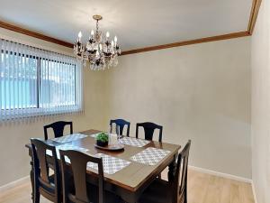 a dining room table with chairs and a chandelier at The Crows Nest in Ruidoso