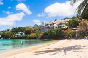 a view of a resort on the beach at Oceans Beach Condo in Morne Rouge