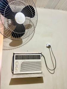 a fan is attached to a wall with a fan at Casa top aeroporto in Macaé