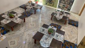 an overhead view of a restaurant with tables and chairs at Rudram Hotel Yoga & Ayurveda Retreat in Rishīkesh