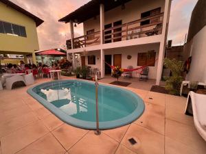a swimming pool in the middle of a house at Casa no francês! in Marechal Deodoro