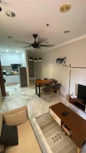 a living room with a couch and a table at Embassy Home KLCC Jalan Ampang in Kuala Lumpur